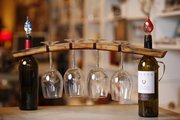 A wine glass holder created from a piece of wood from a wine barrel is among upcycled items for sale at U.R.U Decor, 1113 Massachusetts St.