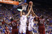 Kansas center Jeff Withey (5) and Kevin Young fight for a rebound with Temple defenders Scootie Randall and Rahlir Hollis-Jefferson during the second half on Sunday, Jan. 6, 2013 at Allen Fieldhouse.