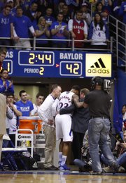 Fans watch as Kansas guard Ben McLemore is helped into the lockerroom late in the second half on Monday, Jan. 14, 2013 at Allen Fieldhouse.