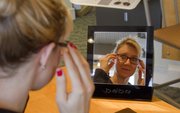 Looking for the right fit and style Sarah Bassett, Lawrence, tries on a pair of new glasses at Crandon and Crandon, 1019 Massachusetts Street.