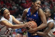 Kansas' Chelsea Gardner, center, battles with Texas Tech's Shauntal Nobles, left, and Chynna Brown for a rebound during the Red Raiders' 70-63 victory Saturday, Jan. 19, 2013, in Lubbock, Texas.