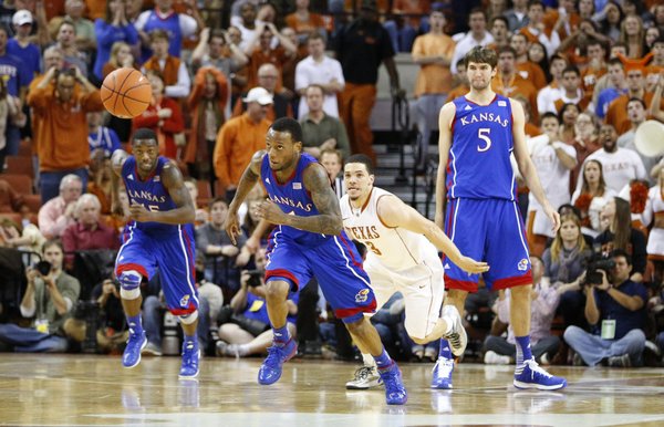 Kansas guard Naadir Tharpe chases down a loose ball past Texas guard Javan Felix late in the second half on Saturday, Jan. 19, 2013 at Frank Erwin Center in Austin, Texas.