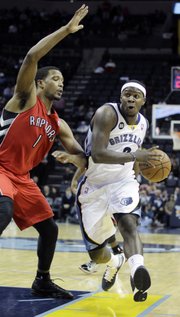 In this Nov. 28, 2012, file photo, Memphis Grizzlies guard Josh Selby (2) works the ball against Toronto Raptors forward Dominic McGuire (1) during the second half of an NBA basketball game in Memphis, Tenn. The Grizzlies have agreed to trade Selby, Marreese Speights, Wayne Ellington, and a future first-round draft pick to the Cleveland Cavaliers for Jon Leuer on Tuesday, Jan. 22, 2013.