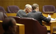 Thomas E. Murray, left, leans in as he talks with his attorney, Adam Hall, on Jan. 23, during a civil case aimed at overthrowing his 2005 sentencing in the November 2003 murder of his ex-wife, Carmin D. Ross at her rural Douglas County home. On Tuesday, a Douglas County judge rejected Murray's argument that his defense attorneys were ineffective.