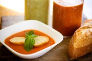 Creamy Tomato soup garnished with slices of baguette and some basil is one of the endless kinds of soups that can be exchanged at parties on National Soup Swap Day on Saturday.