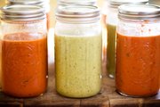Creamy Tomato and Roasted Onion soups are put in jars. If you’re going to a soup swap party, it’s a good idea to freeze soup in glass jars so it doesn’t slosh around, but be sure to leave an extra large amount of head space to avoid causing the jar to break.
