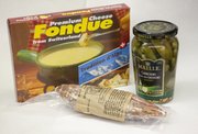 Make a Valentine's Day dinner or late-night snack from Black Truffle Salami, Tradition d’Alps Fondue Cheese and Maille Cornichons, all sold at Au Marché, 931 Massachusetts St.