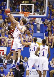 Kansas center Jeff Withey blocks a shot from Oklahoma guard Cameron Clark during the first half on Saturday, Jan. 26, 2013 at Allen Fieldhouse.
