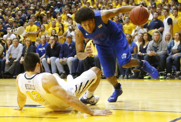 Kevin Young (40) drives the baseline on Deniz Kilicli (13) in the Jayhawks 61-56 win against the Mountaineers Monday night at West Virginia University.
