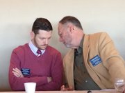 State Reps. John Wilson, D-Lawrence, and Tom Sloan, R-Lawrence, confer Saturday during the Lawrence Chamber of Commerce&squot;s "Eggs and Issues" meeting.