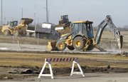 City crews work at the former Farmland property Monday as the city prepares to connect the property to East Hills Business Park. Since 2010, the city of Lawrence has worked to clean up and remove debris from the former Farmland Industries fertilizer plant off Kansas Highway 10. The city took ownership of the 467-acre site with the intention of creating additional space for industrial development and expanding the city’s business park.