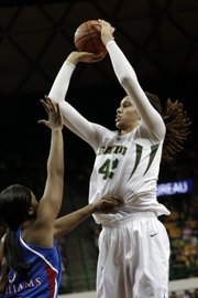 Baylor's Brittney Griner (42) shoots over Kansas' Bunny Williams during the first half of an NCAA college basketball game on Wednesday, Feb. 6, 2013, in Waco Texas. Baylor won 86-45.