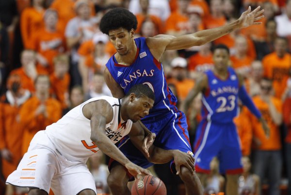 Kansas forward Kevin Young defends against a drive from Oklahoma State guard Marcus Smart during the first half on Wednesday, Feb. 20, 2013 at Gallagher-Iba Arena in Stillwater, Oklahoma.