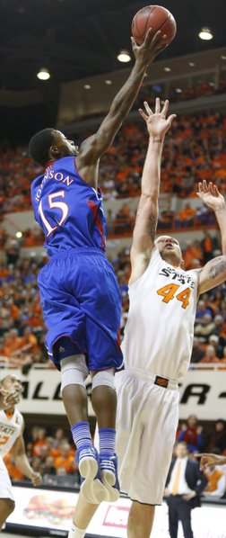 Kansas guard Elijah Johnson floats a shot over Oklahoma State center Philip Jurick during the first half on Wednesday, Feb. 20, 2013 at Gallagher-Iba Arena in Stillwater, Oklahoma.