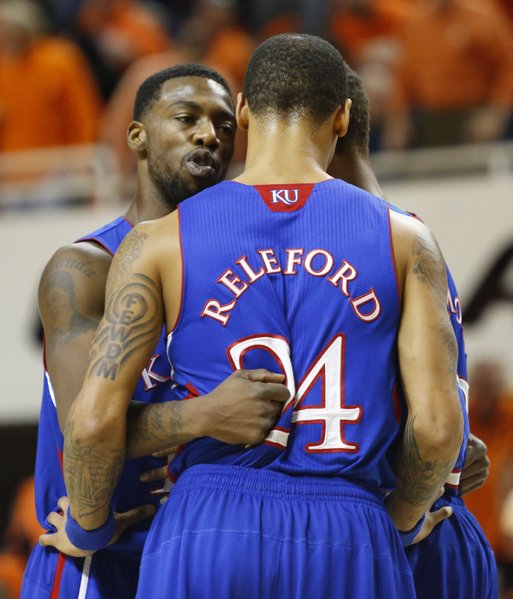 Kansas guard Elijah Johnson huddles up with teammates Travis Releford and Ben McLemore, back, during the first half on Wednesday, Feb. 20, 2013 at Gallagher-Iba Arena in Stillwater, Oklahoma.