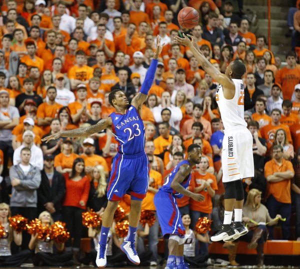 Kansas guard Ben McLemore defends against a shot from Oklahoma State guard Markel Brown during the first half on Wednesday, Feb. 20, 2013 at Gallagher-Iba Arena in Stillwater, Oklahoma.