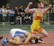 Lawrence High’s Andrew Denning, right, celebrates after defeating Emilio Fowler of Gardner-Edgerton in their Class 6A, 182-pound championship match in the state wrestling tournament Saturday, Feb. 23, 2013, in Wichita.