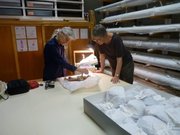 Artists Ann Hamilton, at left, and Cynthia Schira work with objects from the Spencer Museum of Art’s collection in preparation for "An Errant Line," opening Saturday, March 2.