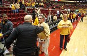 An Iowa State fan is restrained by police after charging at Kansas head coach Bill Self after the Jayhawks' 108-96 overtime win on Monday, Feb. 25, 2013 at Hilton Coliseum in Ames, Iowa.