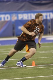 Kansas offensive lineman Tanner Hawkinson runs a drill during the NFL football scouting combine in Indianapolis, Saturday, Feb. 23, 2013.