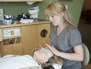 Amy Franklin, Oraspa specialist at Advanced Dental Studio of Joseph R. Gatti, DDS, PA, 5100 Bob Billings Parkway, Suite 110, applies some cooling patches over the eyes of client Patti Pilshaw, Lenexa, on Thursday. The treatment also included soothing music and aromatherapy with a scented spray of chamomile, lavender and rose. Oraspa is a natural option for sedation dentistry that can be used by anyone but is especially effective for those with anxiety about dental work.