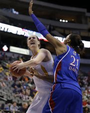 Iowa State’ Anna Prins looks for a shot against Kansas’ Carolyn Davis (21) in the first half on Saturday in the Big 12 women’s tournament in Dallas. ISU won, 77-62.