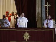 Pope Francis flanked by Monsignor Guido Marini, master of liturgical ceremonies, waves to the crowd from the central balcony of St. Peter's Basilica at the Vatican, Wednesday, March 13, 2013. Cardinal Jorge Bergoglio, who chose the name of Francis is the 266th pontiff of the Roman Catholic Church. (AP Photo/Andrew Medichini)