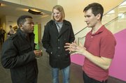 The Rev. Justin Jenkins, right, pastor of Velocity Church, visits with Derock Swaggert, left, and Brysson Rockwell, both of Tampa, Fla., following a Velocity Church service March 10 at Lawrence Arts Center, 940 New Hampshire St.