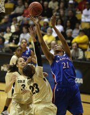Kansas forward Carolyn Davis (21) shoots over Colorado guard Chucky Jeffery (23) and forward Arielle Roberson (32) in the first half of a first-round women's NCAA Tournament game on Saturday, March 23, 2013, in Boulder, Colo.