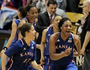Kansas' Monica Engelman (13) and Bunny Williams (5) celebrate with teammates after they defeated Colorado 67-52 in a first-round women's NCAA college basketball game on Saturday, March 23, 2013, in Boulder, Colo.