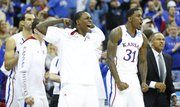 Kansas guard Anrio Adams flexes his muscle after a dunk by Kansas center Jeff Withey against North Carolina during the second half, Sunday, March 24, 2013 at the Sprint Center in Kansas City, Mo.