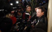 Kansas head coach Bill Self talks with media members upon the team's arrival at the Hyatt Regency Dallas on Wednesday, March 27, 2013.