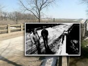 Here's how the bridge near where a triple murder was discovered 40 years ago looks today. The back and white photo shows Franklin County Sheriff's Office Dep. Brad Gilges and Sheriff Rex Bowling standing near the spot at the 25th anniversary of the crime in 1998. The bridge covers Rock Creek, about a mile south of Ottawa.