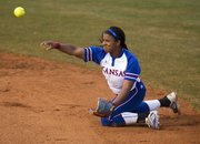 Kansas junior second baseman Ashley Newman makes a throw to first from her knees after making a diving play on the ball during Kansas' softball game against Texas, Thursday, March 28, 2013 at Arrocha Ballpark.