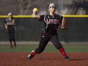 Lawrence High junior Marly Carmona throws to first during Lawrence High's softball game against Shawnee Mission Northwest, Thursday, March 28, 2013 at LHS.