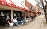 In this 2003 file photo, Kansas University fans wait in front of Jefferson's Restaurant, 743 Massachusetts St., to get a table for the NCAA men's basketball championship game between KU and Syracuse. The line for the night game started forming at 7 a.m. Now, some Lawrence sports bars — including Jefferson's — require minimum food and drink purchases for customers to keep tables on big game days.