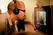 Director Alonso Mayo, a Lawrence native, watches a monitor on the set of his debut feature film “The Story of Luke.” The film, about a young man with a high-functioning developmental disability, was inspired by Mayo’s experiences traveling to Lima, Peru, with his mother, who worked at an organization that provides special education and services to people with developmental disabilities.