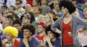 In the two photos above, Kansas University fans display the varied emotions of victory and defeat as they watch the Jayhawks 87-85 loss to Michigan on March 29 at Cowboys Stadium, in Arlington, Texas. Wearing Afro wigs in honor of KU senior Kevin Young are, from left, Janelle Walters, George Dragush, KU freshman Nick Dragush and his girlfriend, KU freshman Mary Bradish, all from Overland Park.