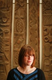 Casey Mesick was recently hired by the Spencer Museum of Art for her expertise in ethnographic collections. She is pictured before a set of four door panels from the Nupe culture in Nigeria.
