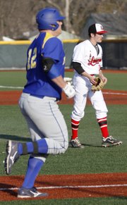Olathe South first baseman Brett Nickle (12) heads for home plate after hitting a home run off Lawrence High pitcher Adam Rea in the Lions' game against Olathe South Thursday, April 4, 2013 at LHS.