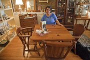 Jane Garvin, Lawrence, ponders over a table and chairs at Tooter and Tillaye's Homegoods, 644 Locust St. The block is gaining an identity as a destination neighborhood for antiques and home decor.