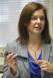 Jamie Simpson is the KU director of accessibility and Americans with Disabilities Act education. She started in March 2012 as the first person in her position at KU. One of the many things she monitors on campus is the opening force required for interior doors. Simpson displays an ADA door-opening force gauge which is used to ensure that the maximum opening force for an interior, non-fire rated door is no more than 5 pounds.