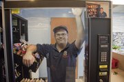 Ryan Banning looks through one of his vending machines at the Lawrence Airport. Banning has operated his own vending machine business, Ryan's Vending Services, for more than a decade. Banning has Down syndrome, a condition that can limit employment options.