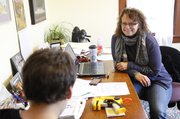Dana Ortiz, executive director of Family Promise of Lawrence, talks with Bryce Fuller, 6, on a recent day at the Family Promise Day Center.