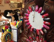 A sample wheel at Nail Arts, 1530 W. Sixth St., shows some of the nail art designs technicians can paint.