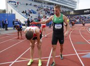 Mile runner Nick Symmonds congratulates Cory Leslie after Leslie took first in the event during the Kansas Relays on Saturday, April 20, 2013 at Memorial Stadium. Symmonds took third behind Leo Manzano. Nick Krug/Journal-World Photo