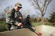Kansas University ROTC Cadet Maj. Nate Kalish, St. Louis, left, runs through a timed assembly of an M4 machine gun with his team partner, Sgt. 1st Class Andrew Acosta, Los Angeles, during the 19th annual Ranger Buddy Competition on Saturday at the Sesquicentennial Park area. Pairs of ROTC cadets competed in six separate obstacle courses and performed various essential tasks for the title of Best Ranger Buddy Team.