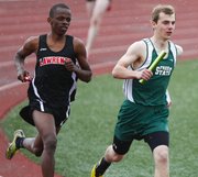 Lawrence High senior John Mwithiga, left, and Free State sophomore Erik Howland keep tight company in the first leg of the boys 4x800 meter relay of the Free State Invitational on Monday, April 22, 2013 at Free State High School.
