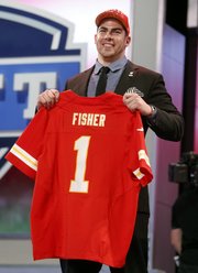 Tackle Eric Fisher from Central Michigan holds up the team jersey after being selected first overall by the Kansas City Chiefs in the first round of the NFL football draft, Thursday, April 25, 2013 at Radio City Music Hall in New York.