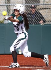 Free State's Kylie Cobb slaps a bunt during the second inning against Shawnee Mission West on Thursday, April 25, 2013, at Free State High.